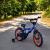Bicicleta 16 inch, roti ajutatoare, cadru otel 23 cm, ghidon reglabil, frane fata v-brake, albastru/portocaliu MultiMark GlobalProd