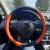 Husa volan din piele ecologica, neagra cu ornamente portocalii Automobile ProTravel