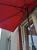 Umbrela balcon 270x250 cm, montaj pe perete, cu manivela si husa impermeabila, poliester 180g/mp, rosu Household NewTrend