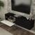 Comodă TV suspendată Verpsboga 135x32x30 cm, neagră, front 3D